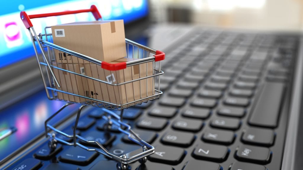 E Commerce Shopping Cart With Cardboard Boxes On Laptop 3d